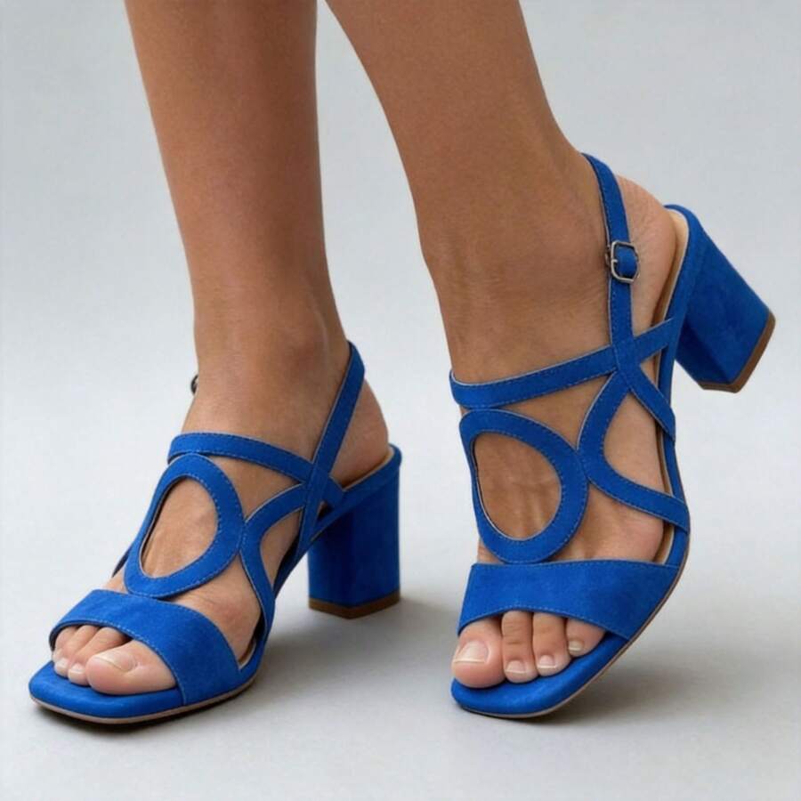 Three-quarter view of cobalt blue open toe square toe block heel sandals on model
