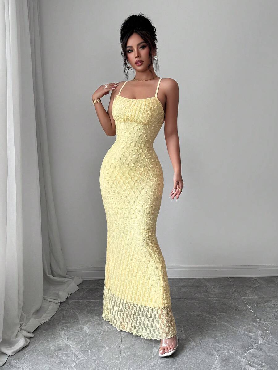Full front view of light-yellow spaghetti-strap mermaid evening gown