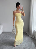 Mirror front view of textured light-yellow mermaid maxi dress with chain bag