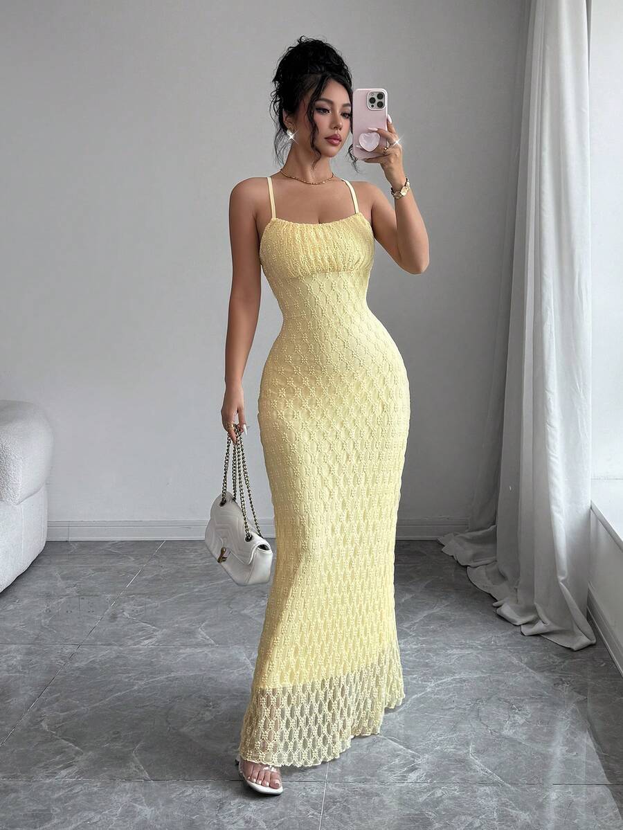 Mirror front view of textured light-yellow mermaid maxi dress with chain bag
