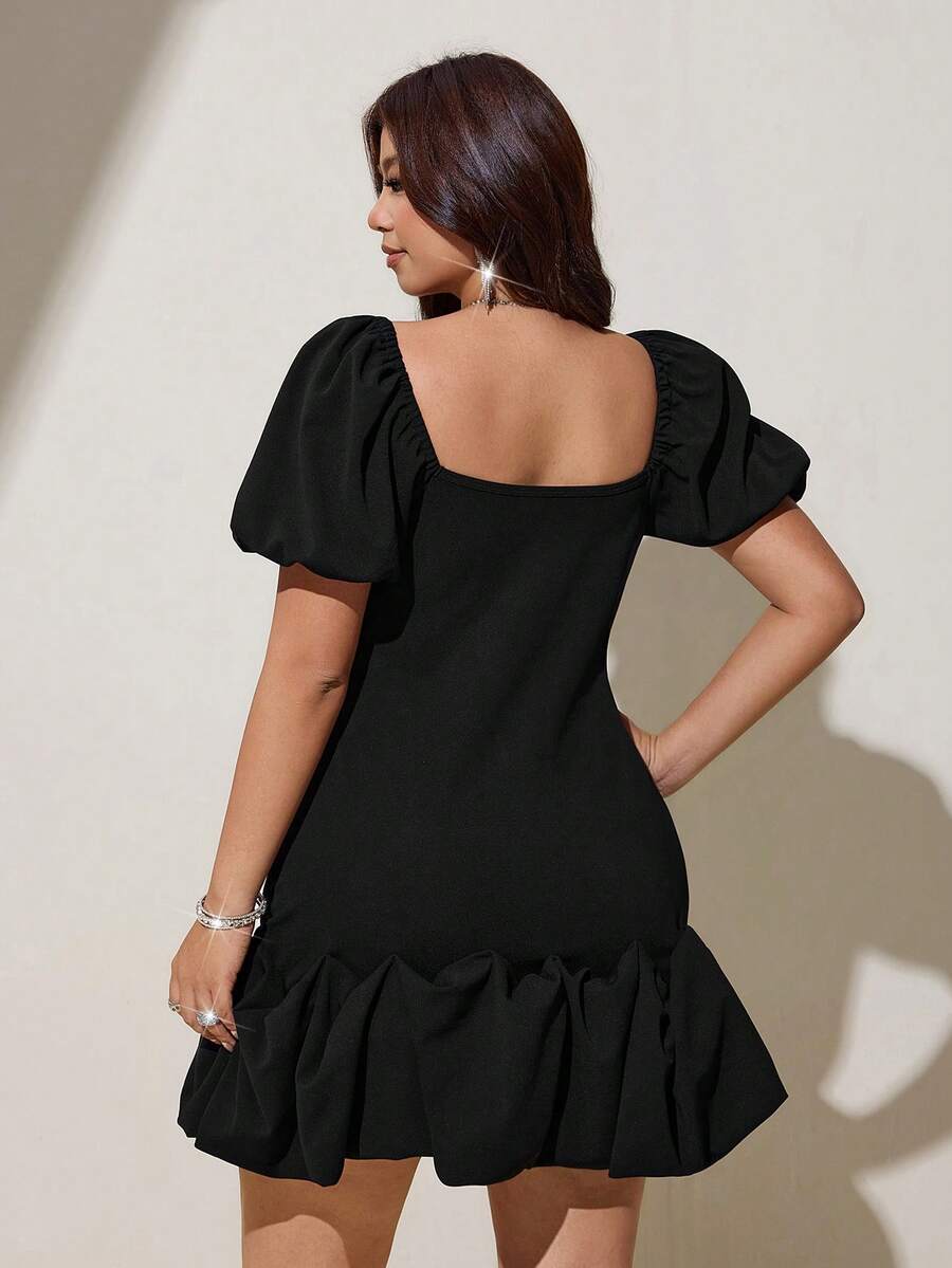 Black fitted mini dress with puff sleeves and gathered bubble hem