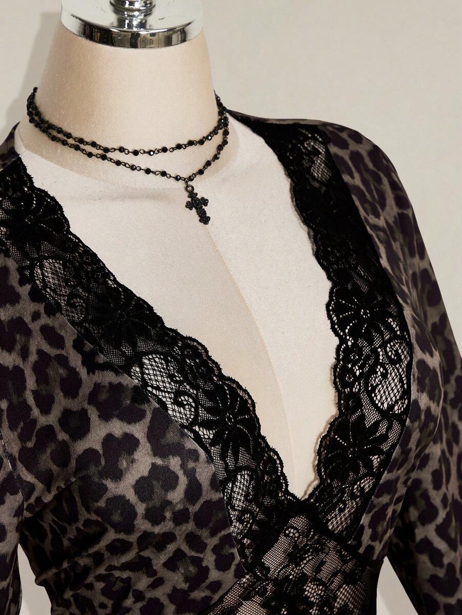 Close-up of black floral lace crossing the deep V neckline on leopard print dress