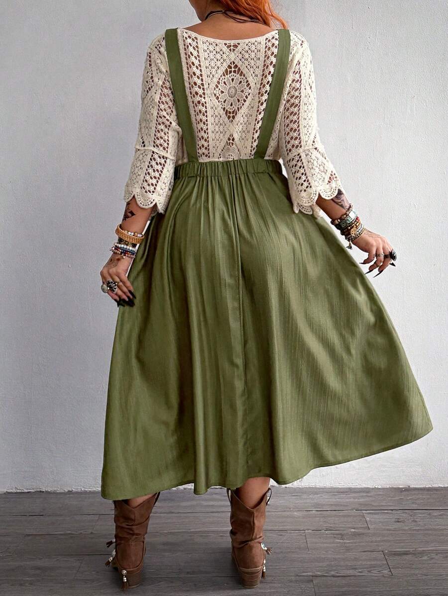 Back view of army green pinafore dress with wide straps and gathered waist