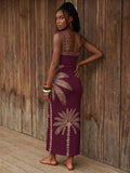 Back view of burgundy palm print one-shoulder maxi dress with open back