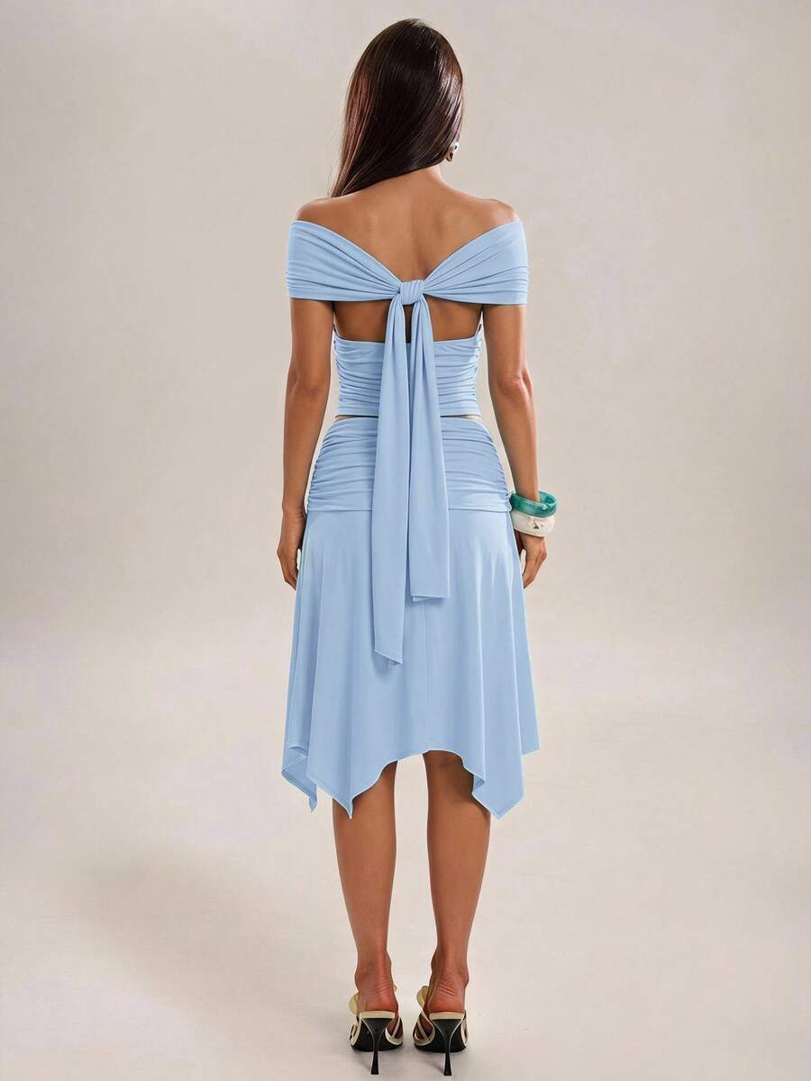 Yellow two-piece skirt outfit with open back tie and handkerchief hem