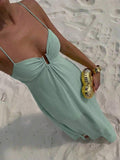 Close front view of mint green keyhole gathered bodice maxi dress on beach