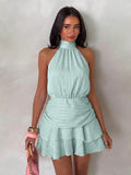Front view of mint green halter mini dress with gathered waist and tiered hem