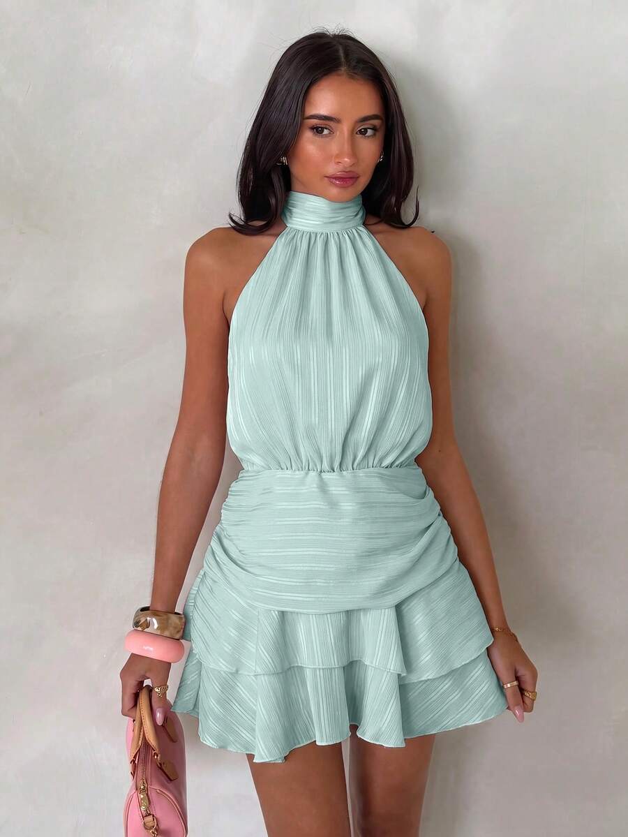 Front view of mint green halter mini dress with gathered waist and tiered hem
