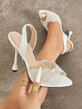 White pearl-and-rhinestone slingback sandal with pointed open toe and stiletto heel