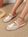 Side on-foot view of ivory woven Mary Jane flat showing buckle strap and low sole