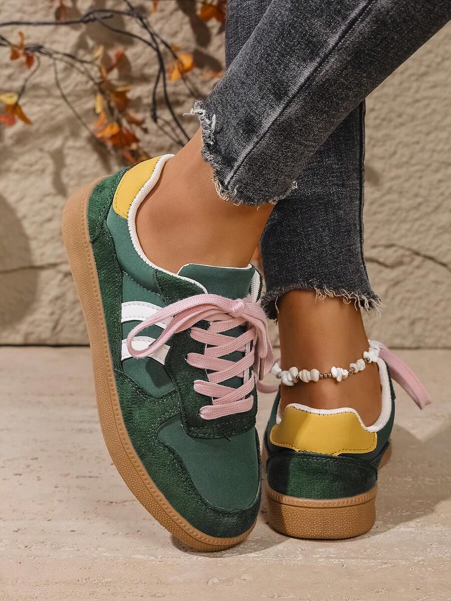Rear-side view of green and yellow stripe sneakers with layered panels and gum soles