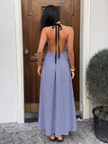 Back view of navy gingham backless halter maxi dress