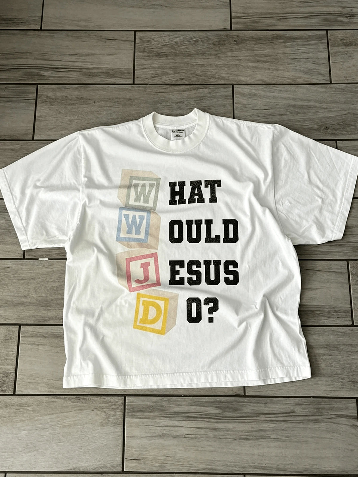 White What Would Jesus Do graphic T-shirt front flat lay