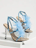 Studio display view of baby blue snakeskin 3D floral cross-strap square-toe stiletto sandals with metallic heel