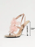 Side display view of baby pink snakeskin 3D floral cross-strap square-toe stiletto sandals with metallic heel