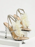 Studio display view of white and beige 3D floral cross-strap square-toe stiletto sandals with metallic heel