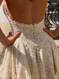 Back close-up of the cream lace mini dress showing an open back, scalloped edge and covered button row