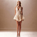 Full-length front studio view of a cream floral lace mini dress styled with light-colored flats