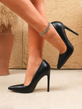 worn crossed-leg view of black pointed-toe stiletto pumps for evening styling