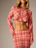 Close-up of the plaid crop blouse round neckline, center zipper, and long sleeve