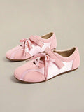 Pair of pale pink low-top sneakers with laces, hook-and-loop straps, and flat brown gum soles