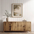 Neutral framed olive tree and coastal landscape print above a wooden console, part of a Psalm 46:10 scripture canvas gallery set