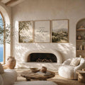 Psalm 46:10 triptych displayed above a living-room fireplace, with olive tree and village landscape prints flanking the verse