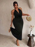 Front view of black plus size halter maxi dress with gold collar and draped neckline