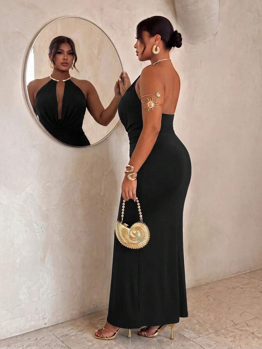 Side view of black backless halter maxi dress with fitted long skirt