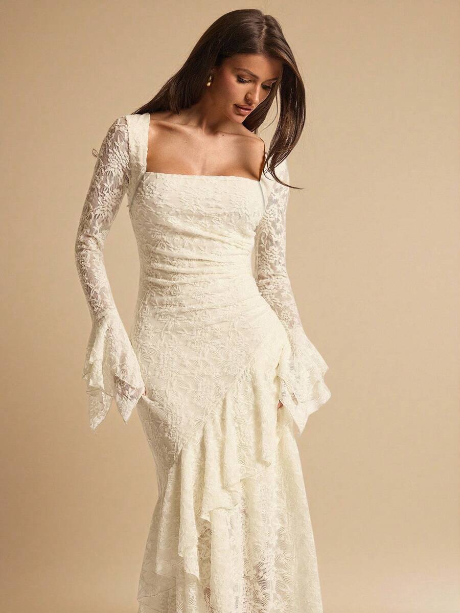 Close front view of an ivory lace dress showing the square neckline, ruched waist and long flared sleeve cuffs