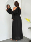 Back view of black halter tie-back maxi dress with sheer hem