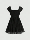 Black puff-sleeve polka-dot dress with flared skirt