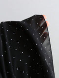 Black ruffle mini dress with gathered bodice and polka dots