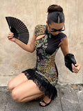 Seated outdoor view of multicolor bodycon party dress with layered sheer black lace hem
