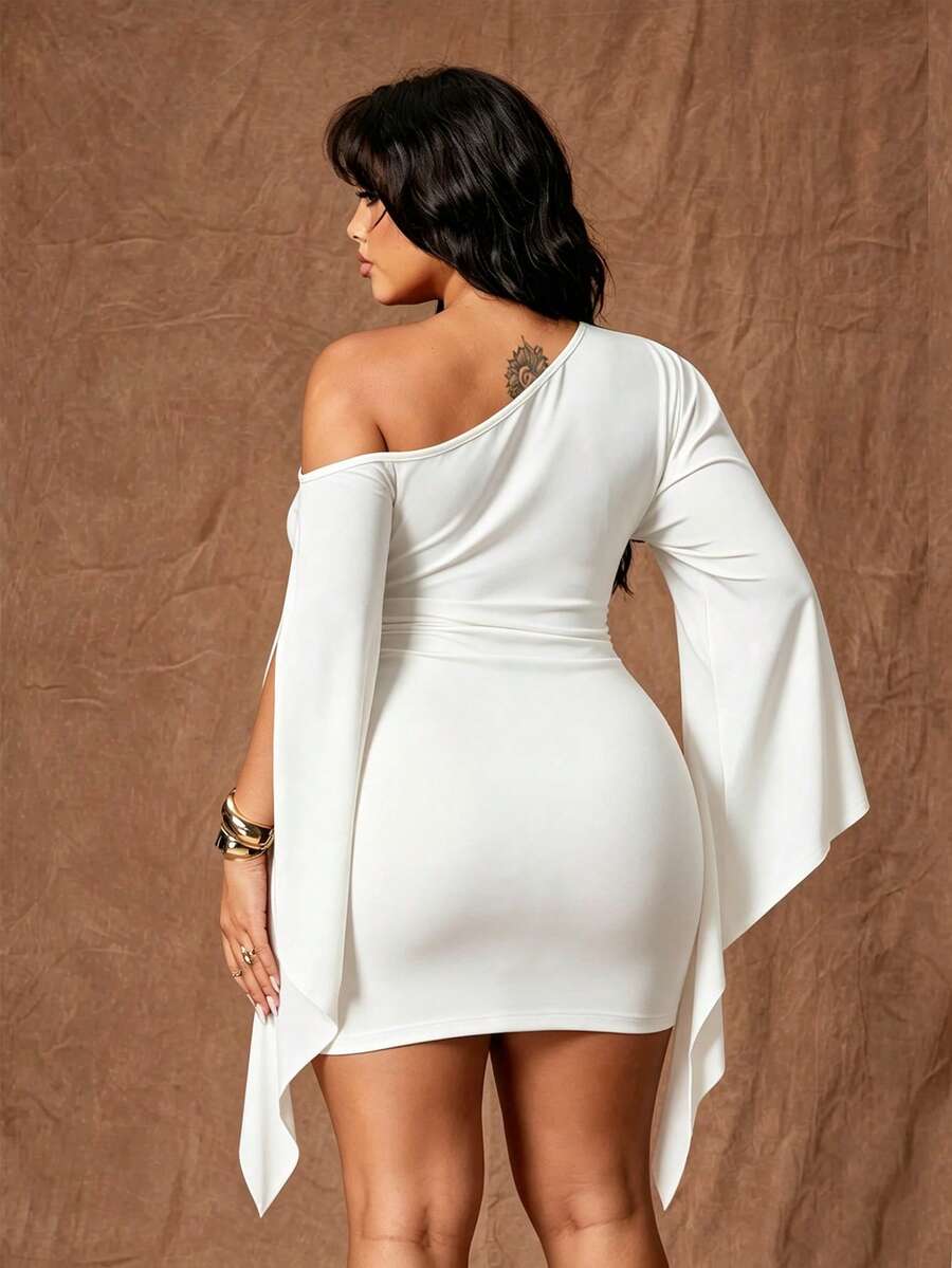 Back view of white fitted mini dress with asymmetrical neckline and draped sleeves