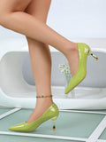 Patent-look pointed toe heel with flared gold heel tip