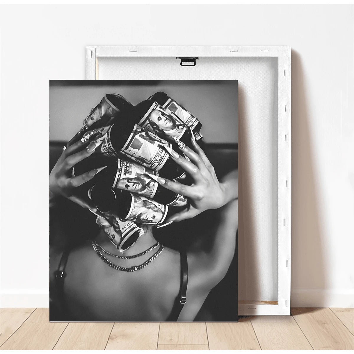 Unframed black and white dollar bill artwork beside canvas frame