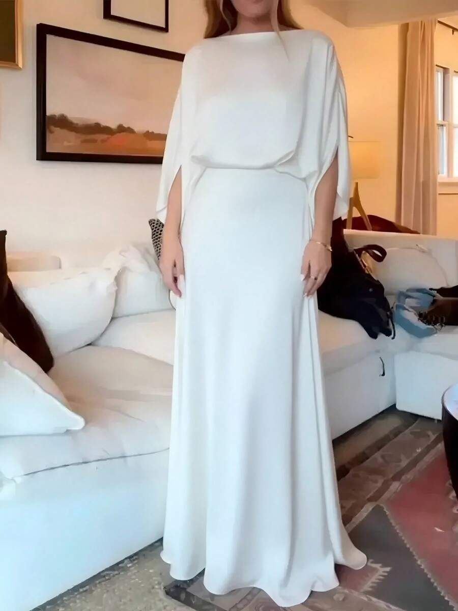 Ivory gown shown full length in a living-room setting, front view