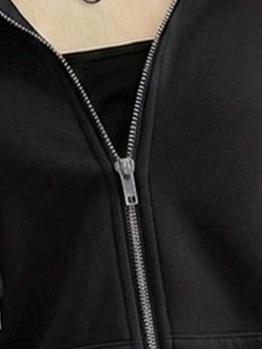 Close-up of black hoodie metal zipper and smooth knitted fabric