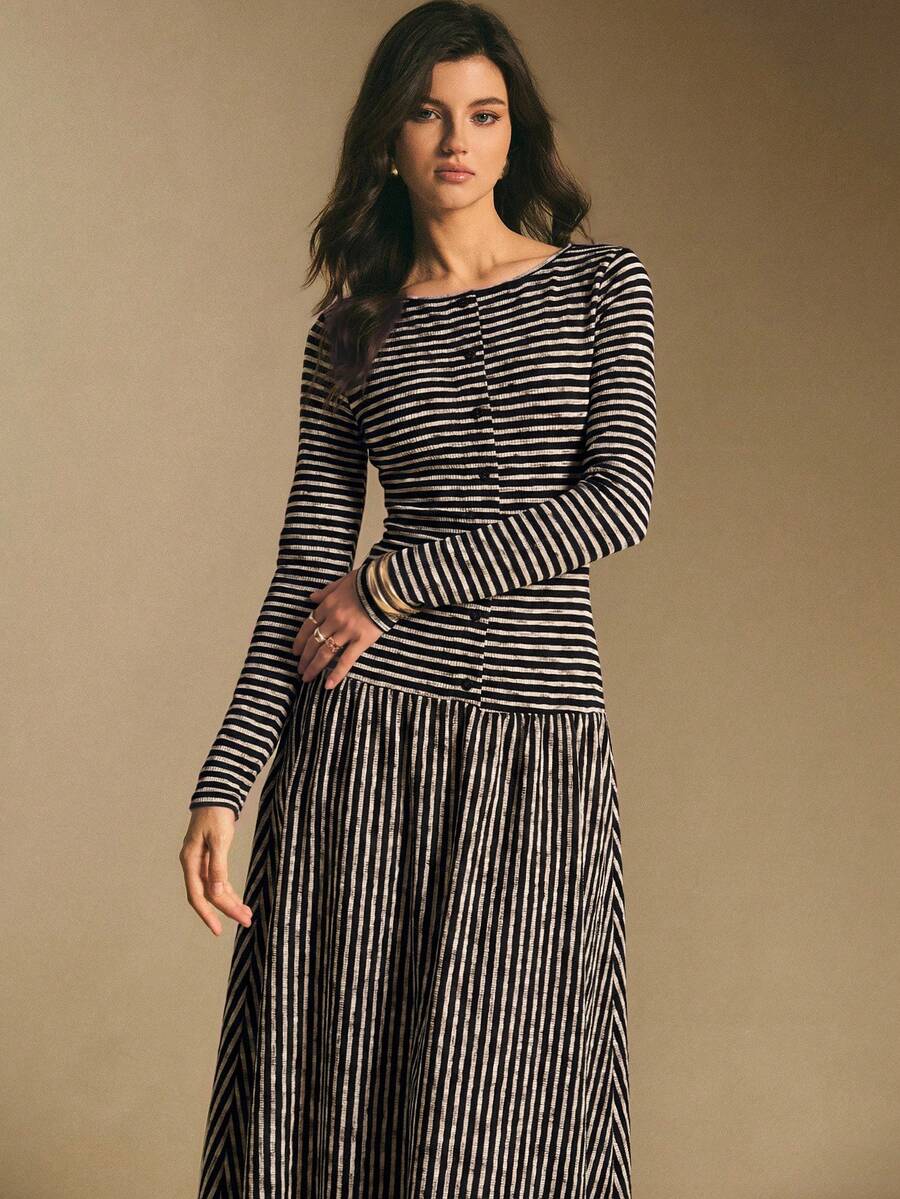 Back view of the black and cream striped maxi dress showing horizontal stripes on the bodice and vertical stripes on the skirt