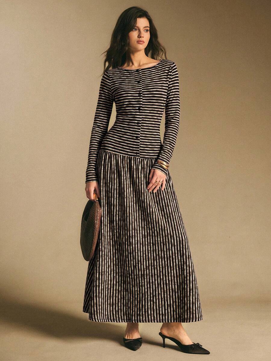 Front view of a black and cream striped long-sleeve maxi dress with horizontal bodice stripes and vertical skirt stripes