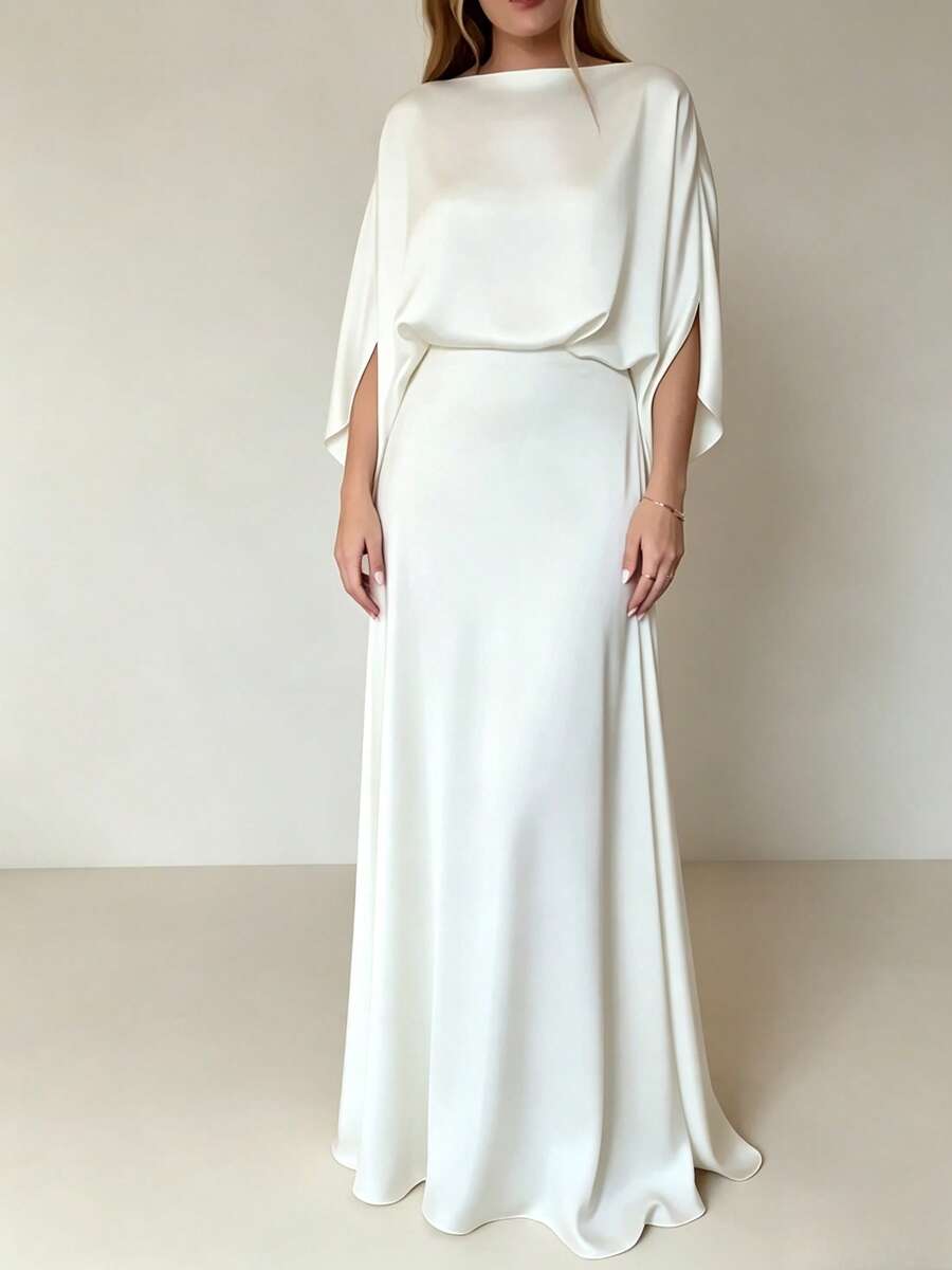 Ivory white floor-length gown with boat neck and cape-like batwing sleeves, studio view