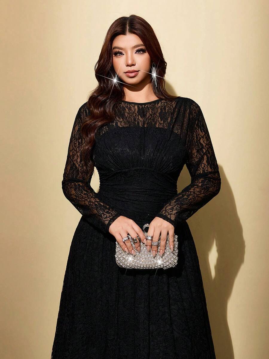 Back view of black floral lace maxi dress with sheer panels and long flared hem