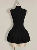 Back view of black sleeveless pleated mini dress with high collar and center zipper