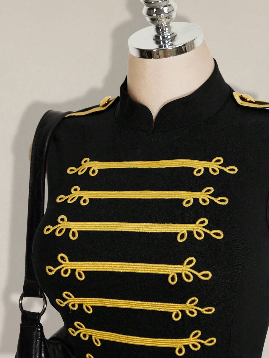 Close-up of black cheongsam collar dress with gold braided trim and shoulder epaulette