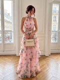 Front view of aqua botanical halter crop top and tiered maxi skirt