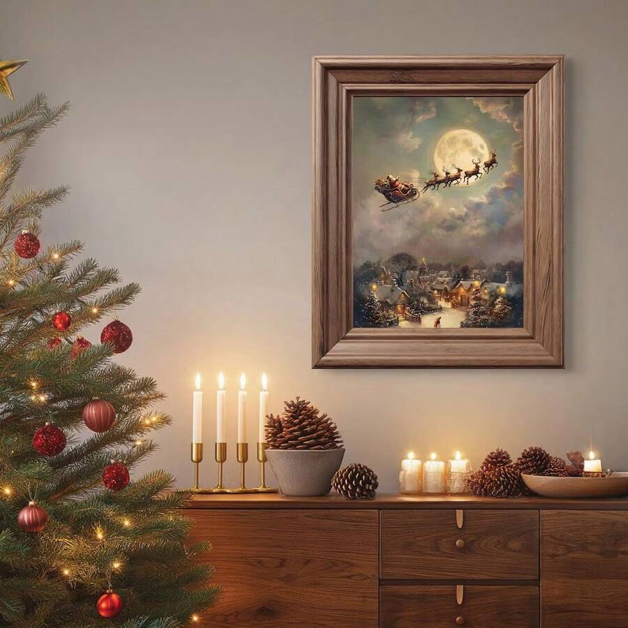 Framed Santa sleigh and snowy village print above a console in a Christmas-decorated room.