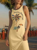 Front close-up of butter yellow tropical toucan maxi dress by waterfront