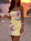 Light yellow fitted mini dress with dimensional flower appliqué at the bodice