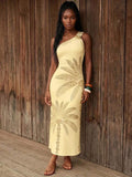 Front view of pale yellow botanical print one-shoulder maxi dress with floral brooch